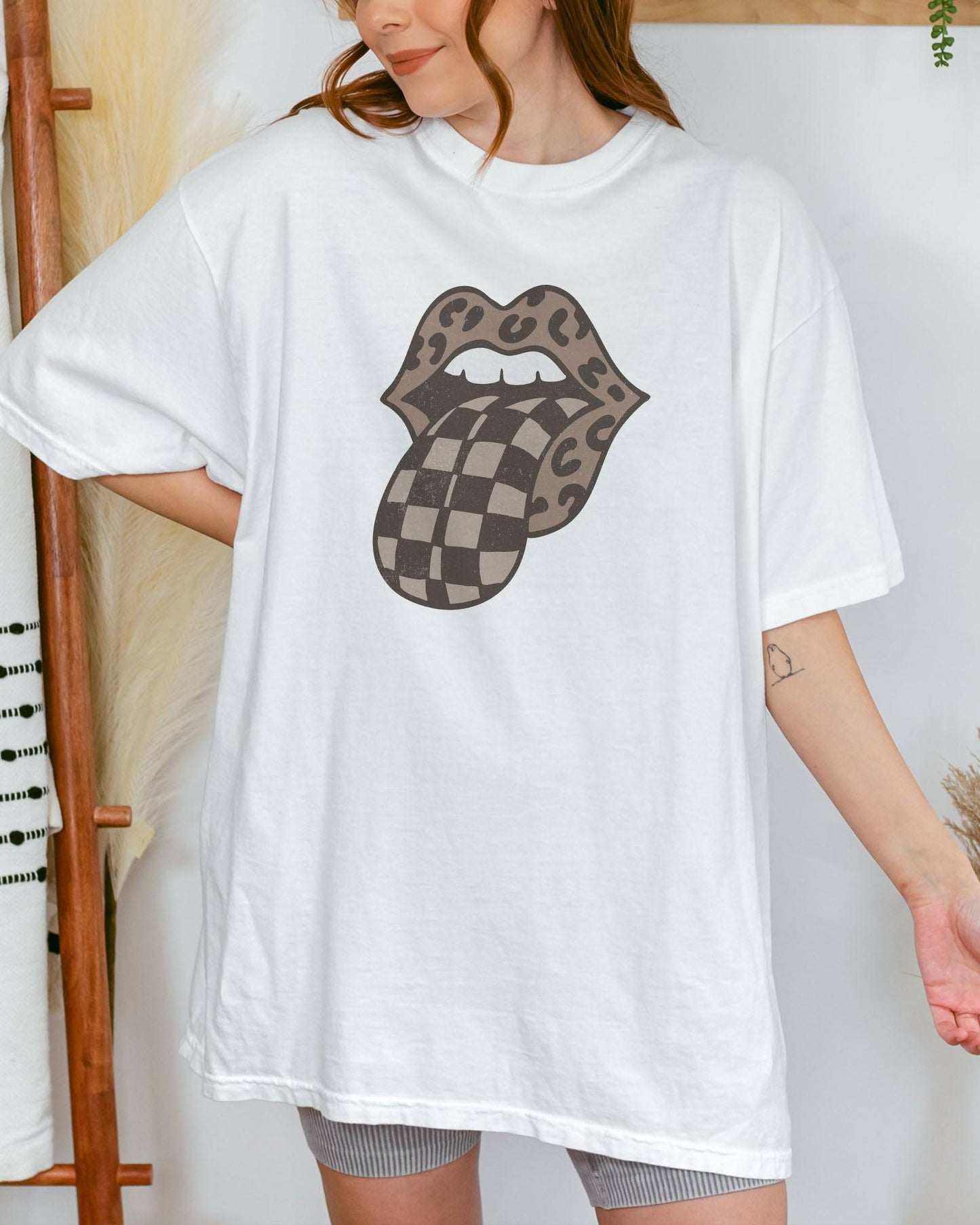 Model wearing white color shirt with 'Leopard Mouth Checkered Tongue' graphic design