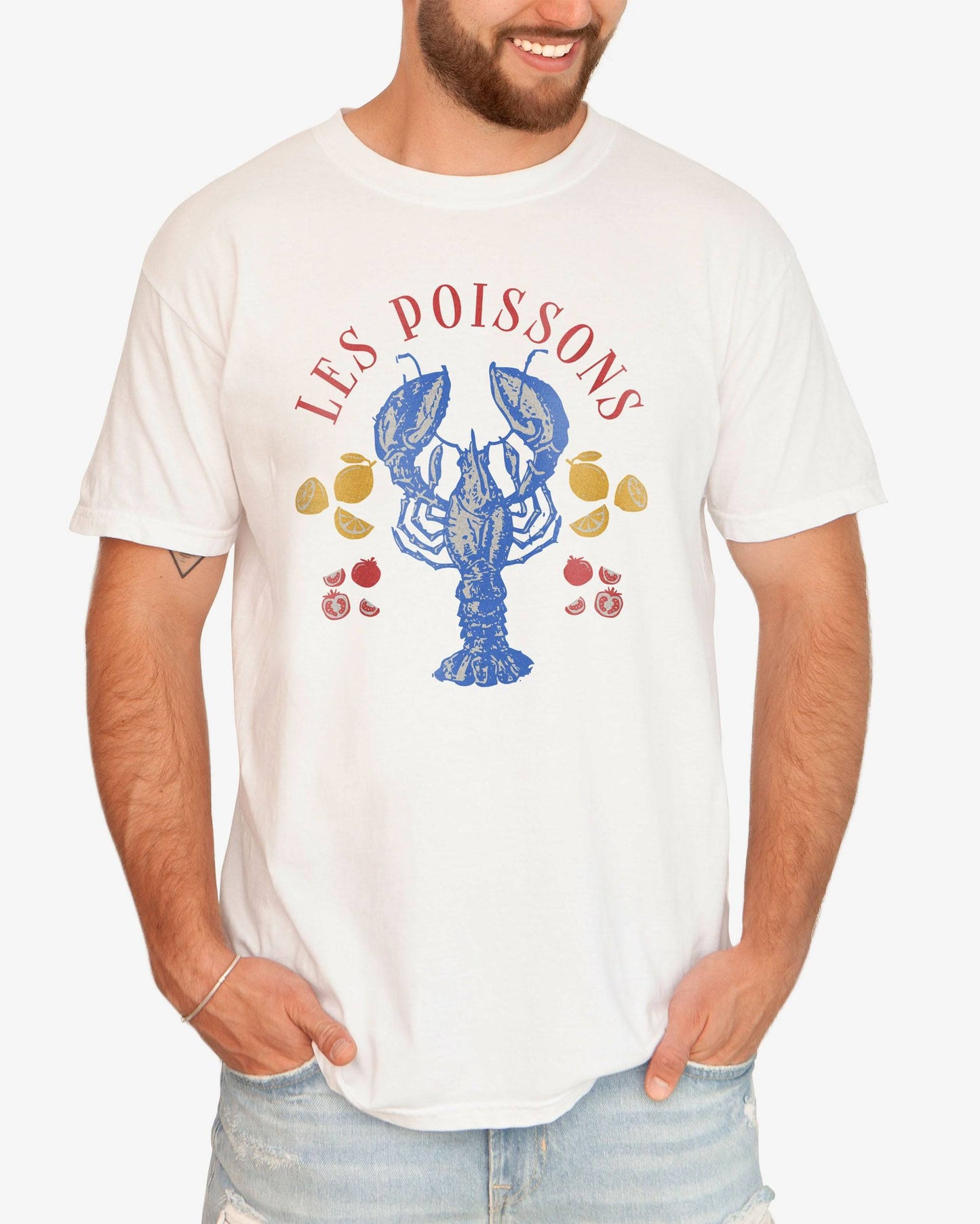 Man wearing a white 'Les Poissons' shirt with a retro graphic of a lobster.