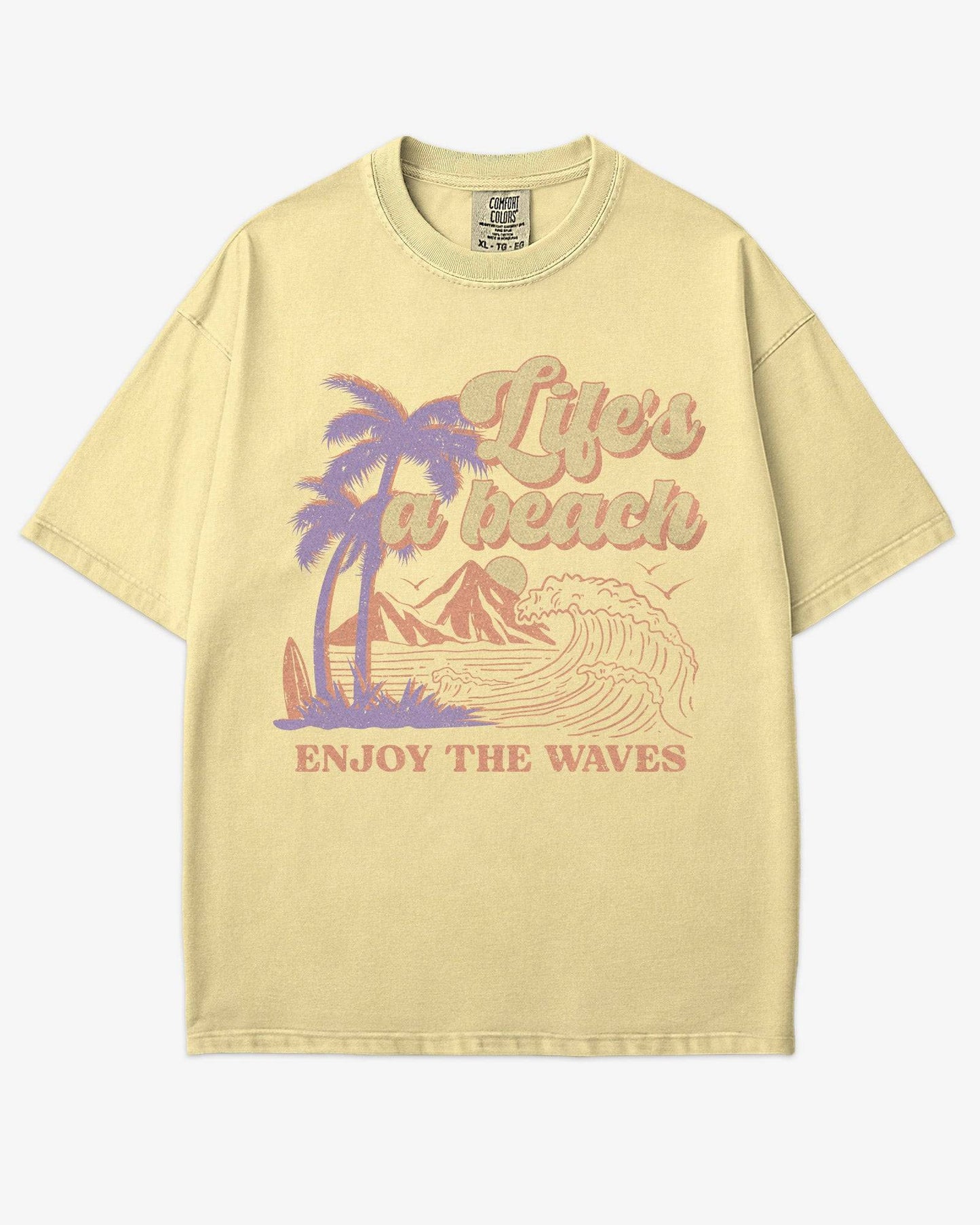 Life’s A Beach – Enjoy The Waves retro surf graphic t-shirt in butter with beach and waves design.