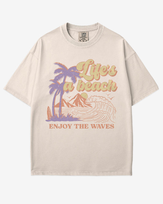 Life’s A Beach – Enjoy The Waves retro surf graphic t-shirt in ivory with beach and waves design.