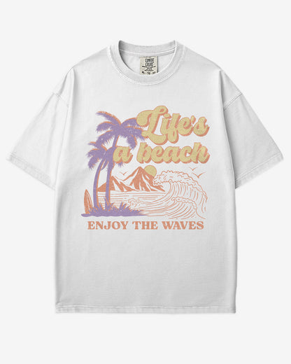 Life’s A Beach – Enjoy The Waves retro surf graphic t-shirt in white with beach and waves design.