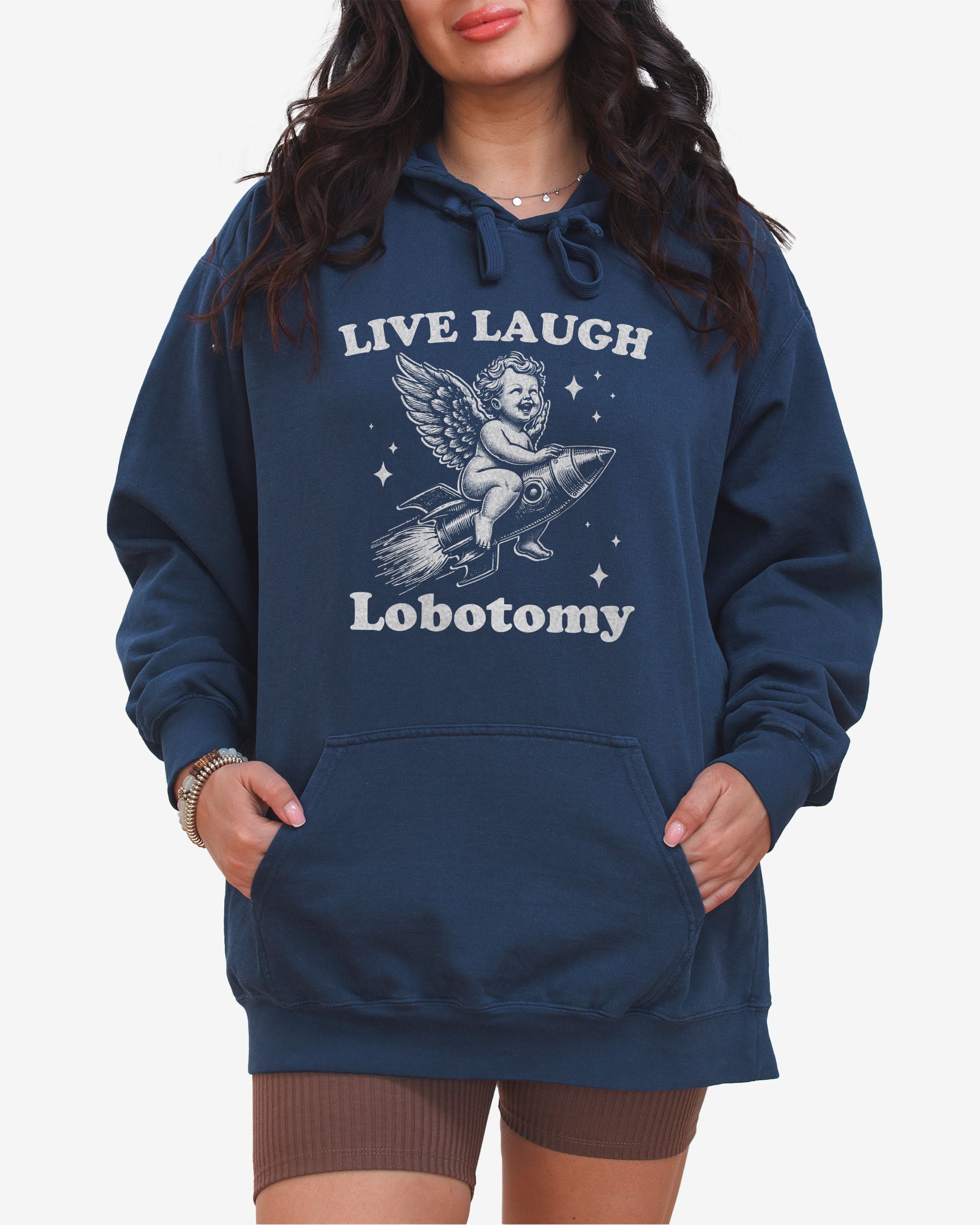 Woman wearing true navy 'Live Laugh Lobotomy' hoodies with funny retro graphic of armor flying on a rocket.