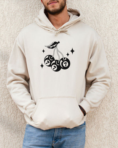 Man wearing sand beige hoodie featuring a retro lucky 7 eightball cherries graphic.