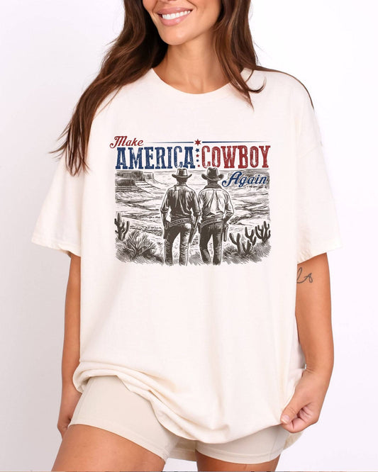 Model wearing natural color shirt with 'Make America Cowboy Again' graphic design