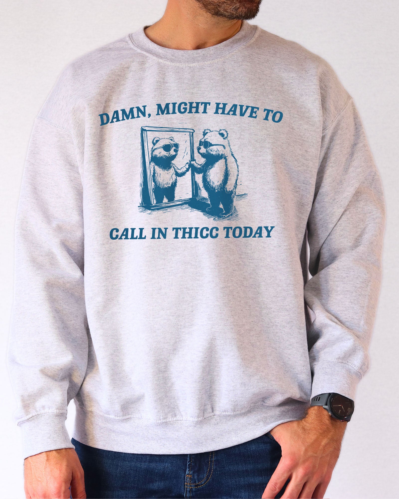 Model wearing ash color sweatshirt with 'Damn, Might Have To Call in Thicc Today' graphic design