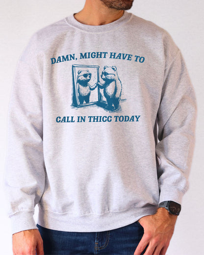 Model wearing ash color sweatshirt with 'Damn, Might Have To Call in Thicc Today' graphic design