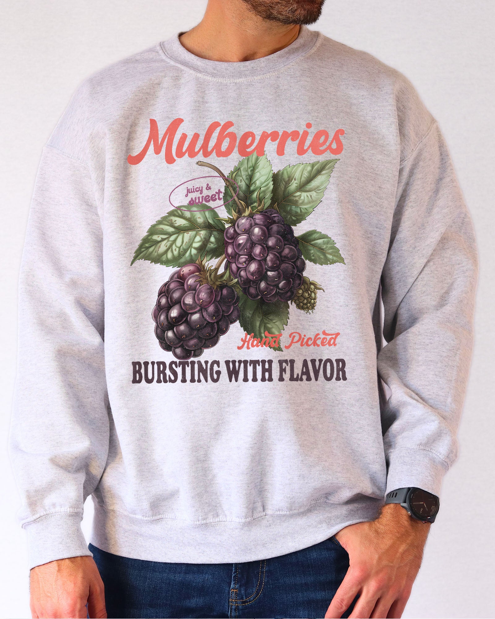 Model wearing ash color sweatshirt with mulberries fruit graphic design