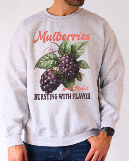 Model wearing ash color sweatshirt with mulberries fruit graphic design