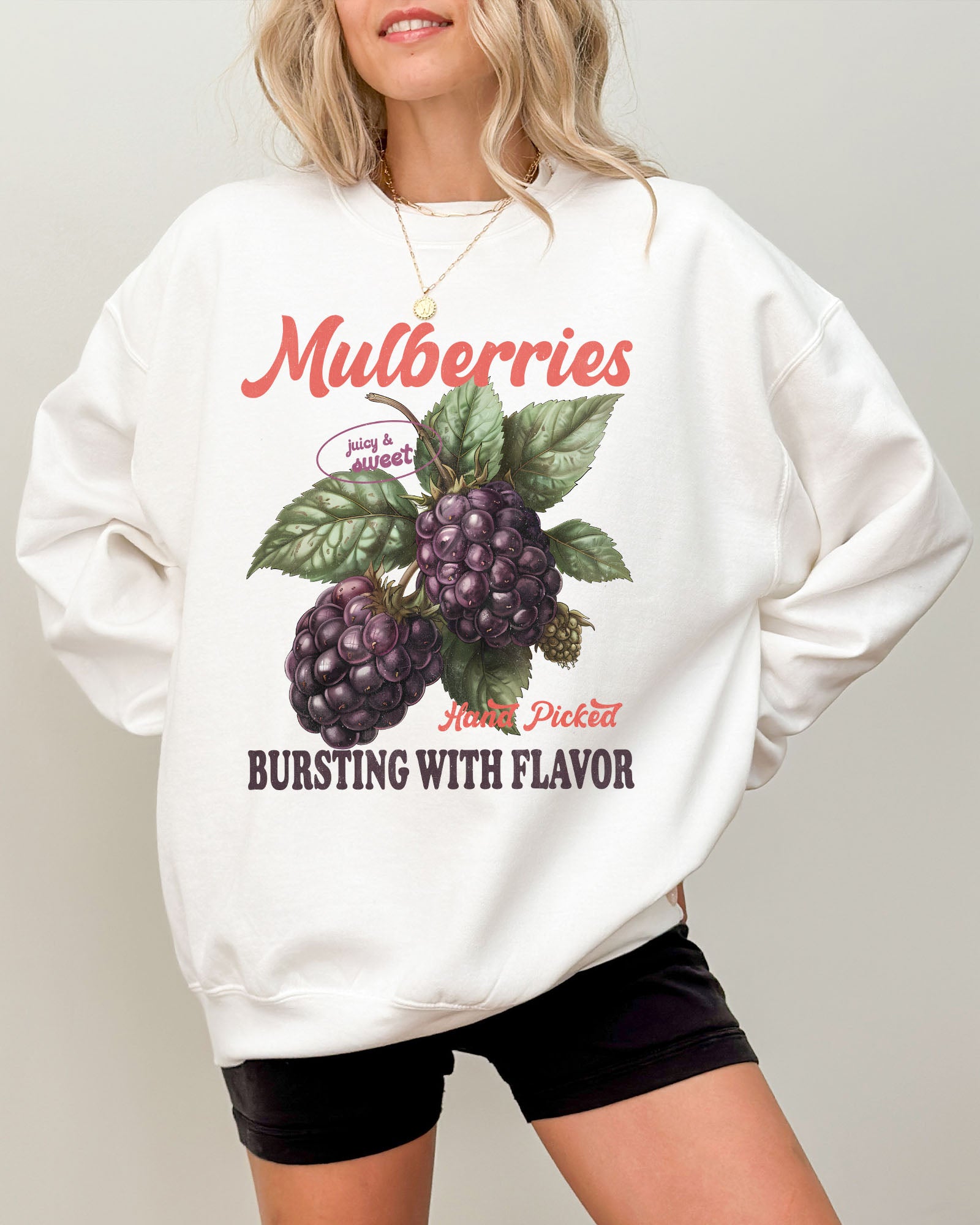 Model wearing white color sweatshirt with mulberries fruit graphic design