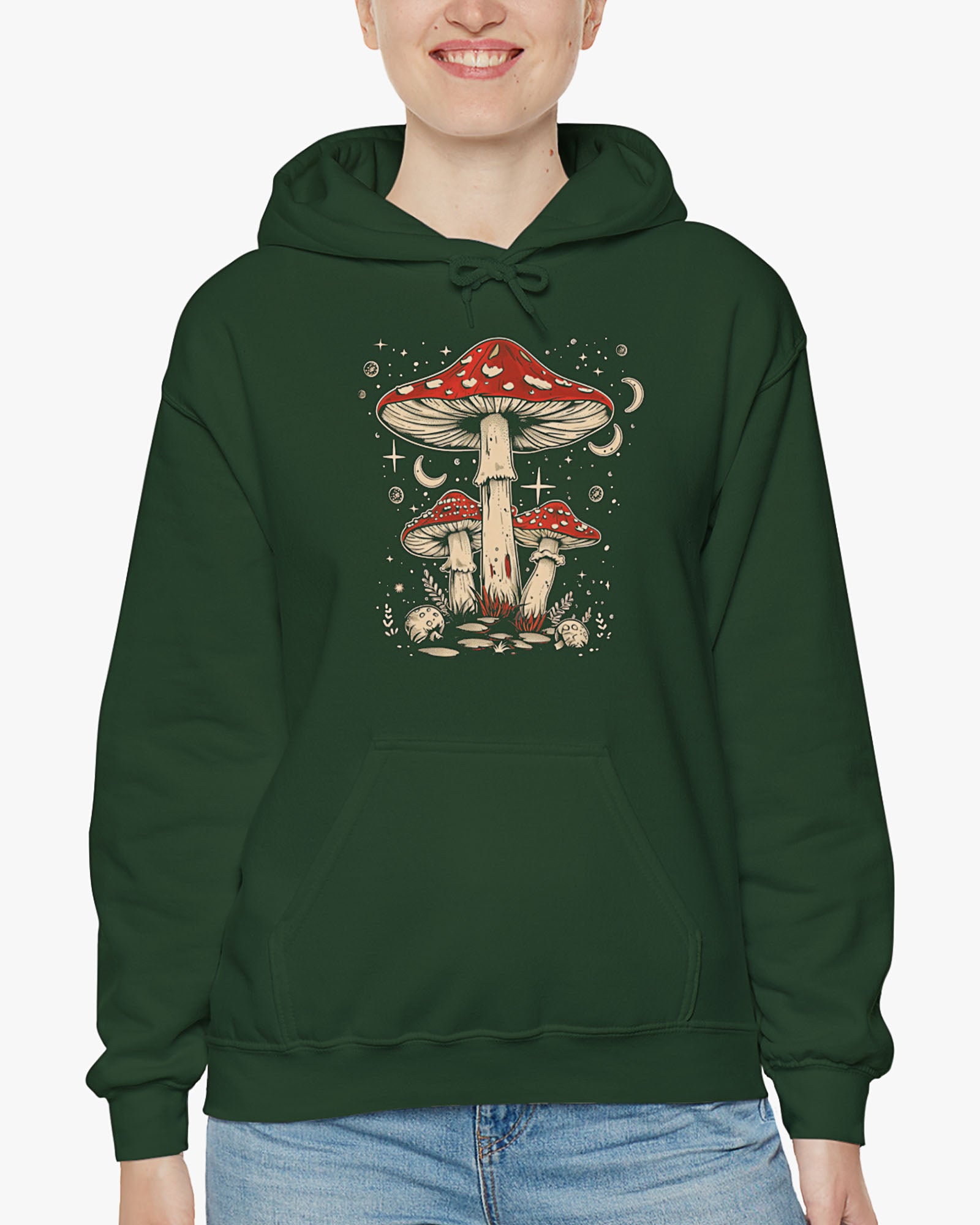 Woman wearing a forest green hoodie featuring a retro mushroom graphic with a starry night sky background.
