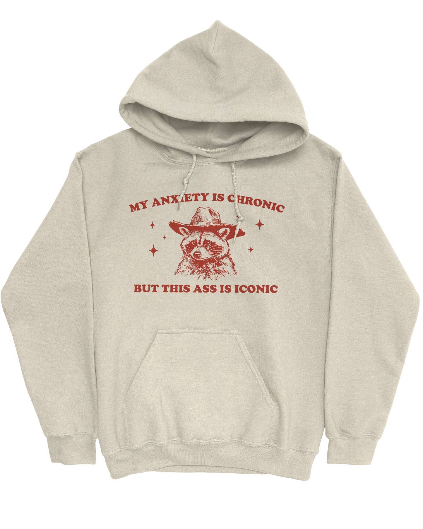 Flat lay of a sand beige 'My Anxiety Is Chronic But This Ass Is Iconic' hoodie featuring a funny retro cowboy raccoon graphic.