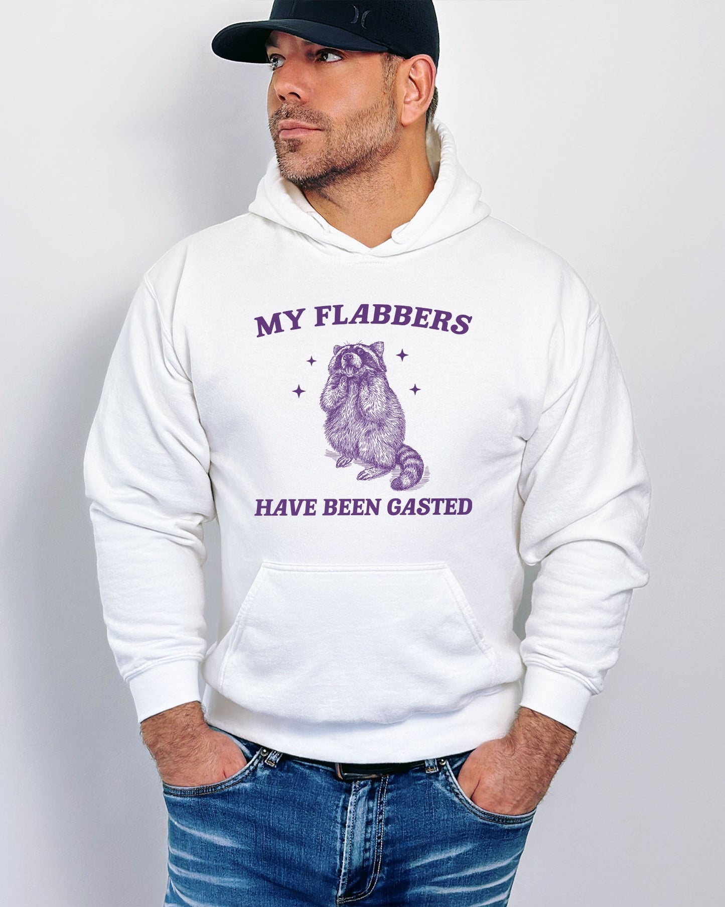 Man wearing a white 'My Flabbers Have Been Gasted' hoodie featuring a funny retro raccoon freaking out graphic.