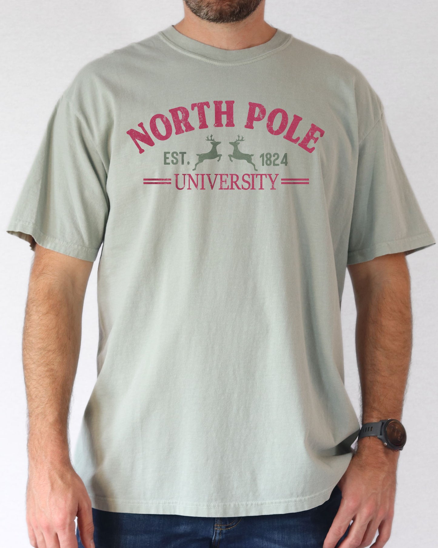 Man wearing bay-colored "North Pole University" shirt.
