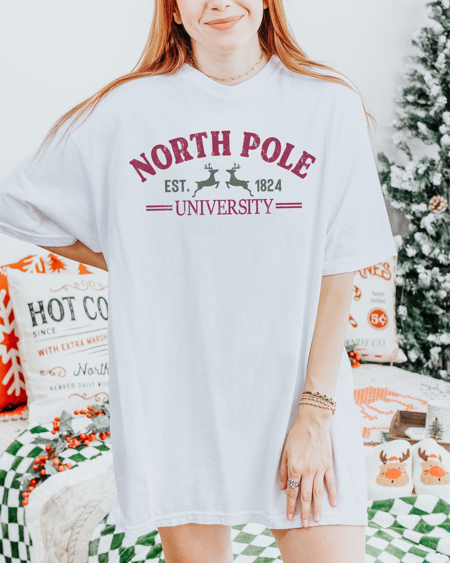 Woman wearing a white "North Pole University" shirt.