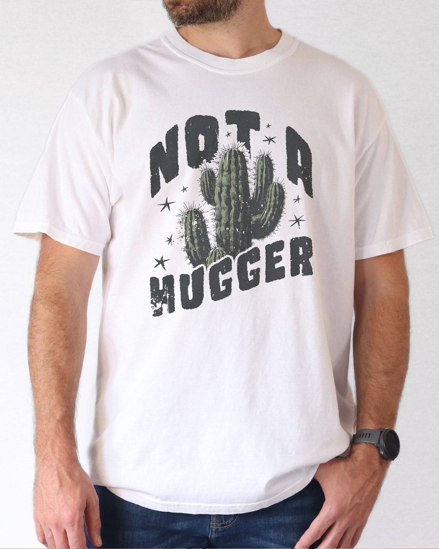 Model wearing white color shirt with 'Not A Hugger' cactus graphic design