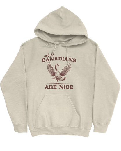 Flat lay sand-colored 'Not All Canadians Are Nice' hoodie featuring a funny canadian goose retro graphic.