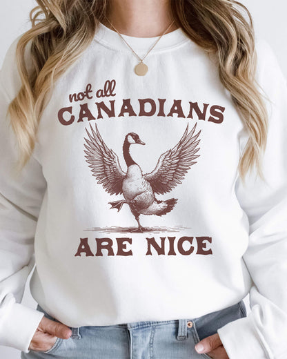 Woman wearing a white sweatshirt featuring a funny retro bird graphic and the quote 'Not All Canadians Are Nice'.