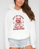 Woman wearing a white 'Not My Trash, Not My Dumpster' hoodie with a funny retro raccoon drinking coffee graphic.