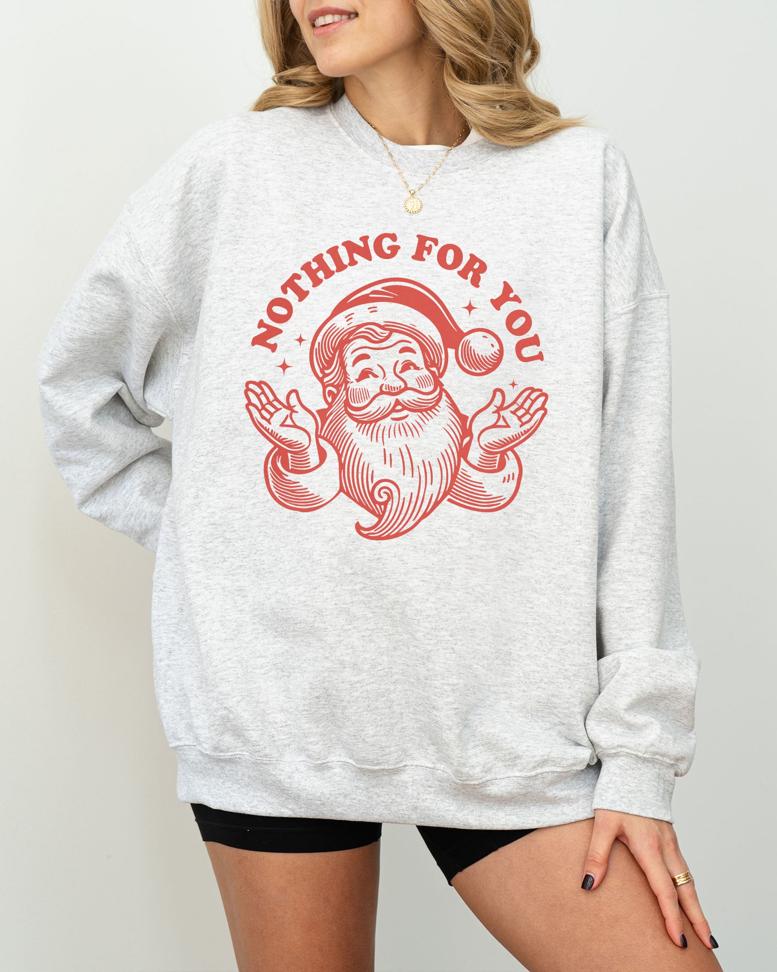 Model wearing ash color sweatshirt with 'Nothing For You' Santa Claus graphic design