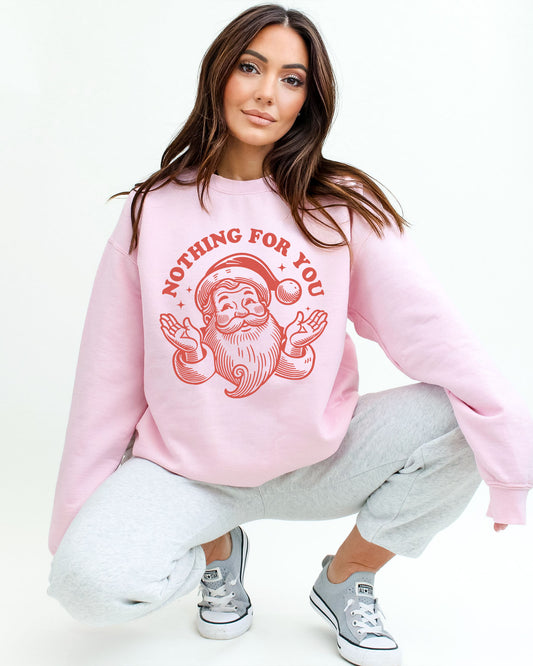 Model wearing light pink color sweatshirt with 'Nothing For You' Santa Claus graphic design