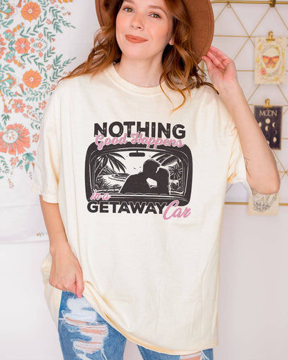 Model wearing ivory color shirt with 'Nothing Good Happens In A Getaway Car' graphic design