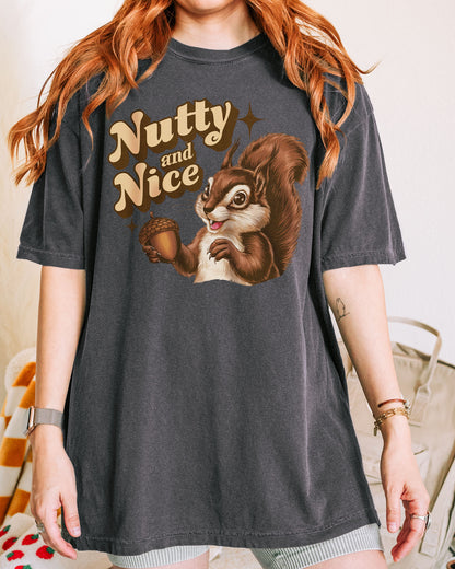 Woman wearing a pepper-colored ‘Nutty and Nice’ shirt with a retro graphic of a squirrel.