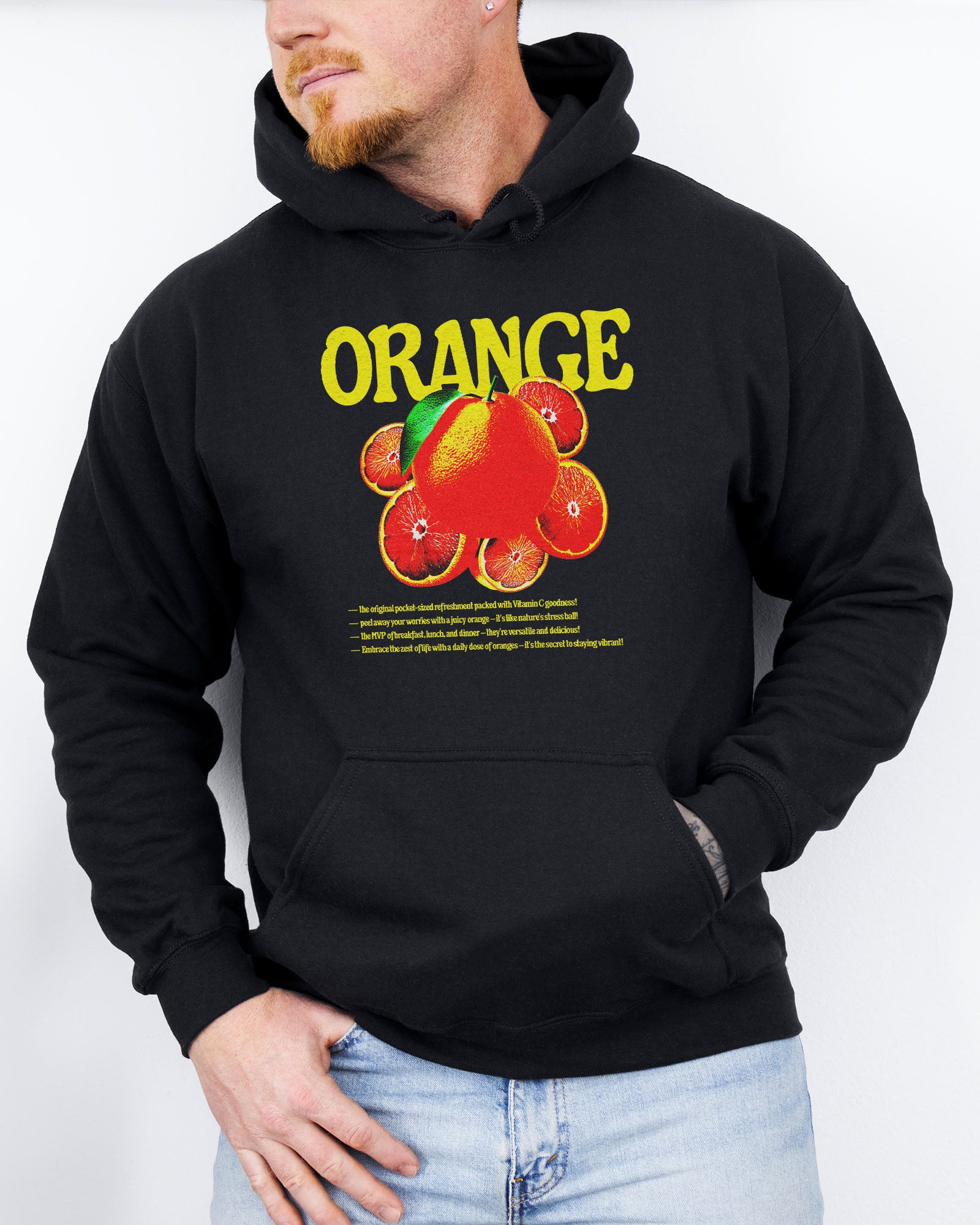 Man wearing a black hoodie featuring a retro orange fruit graphic.