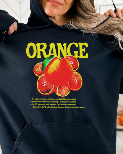 Woman wearing a black hoodie featuring a retro orange fruit graphic.