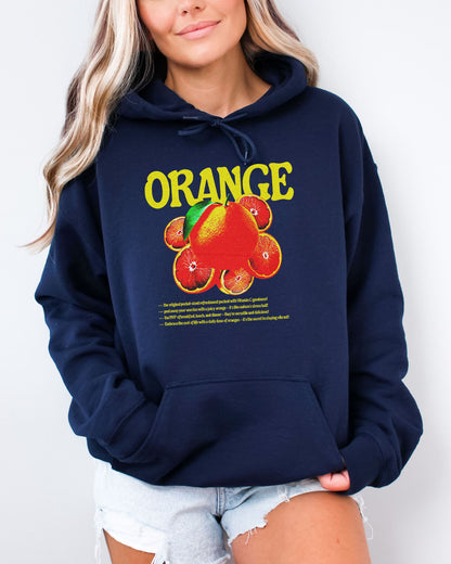 Woman wearing a navy blue hoodie featuring a retro orange fruit graphic.