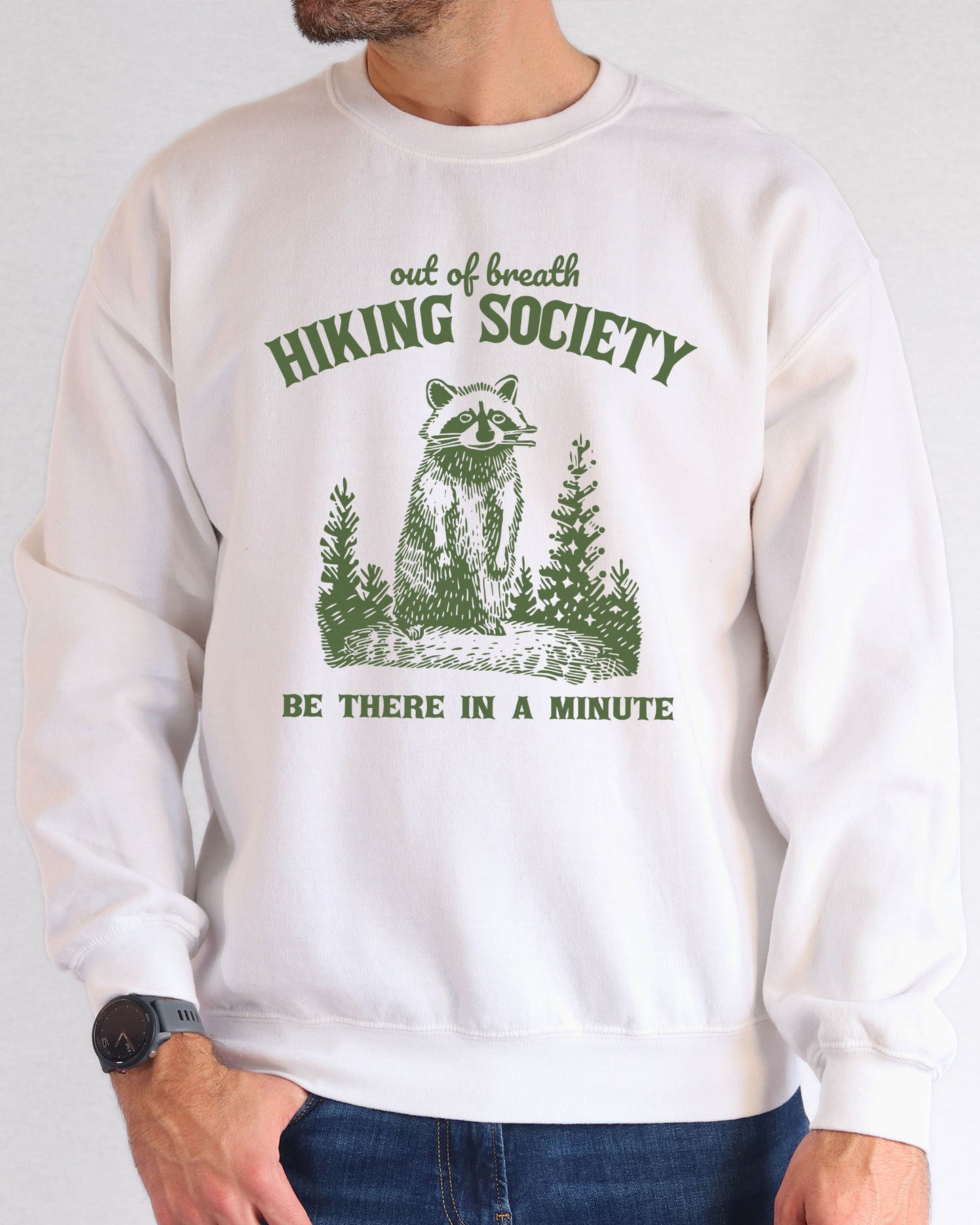 Model wearing white color sweatshirt with 'Out Of Breath Hiking Society' graphic design