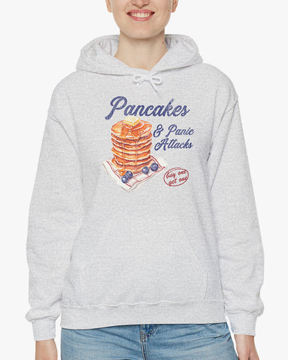 Woman wearing ash gray 'Pancakes And Panic Attacks' hoodie with retro distressed pancakes graphic