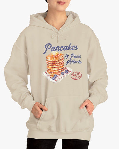 Woman wearing sand beige 'Pancakes And Panic Attacks' hoodie with retro distressed pancakes graphic