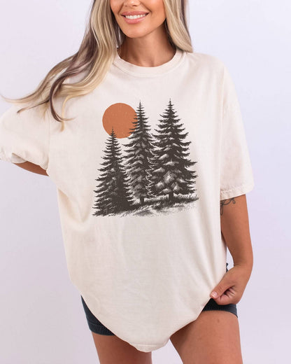 Model wearing ivory color shirt with pines and sun retro nature graphic design