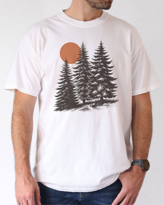 Model wearing ivory color shirt with pines and sun retro nature graphic design