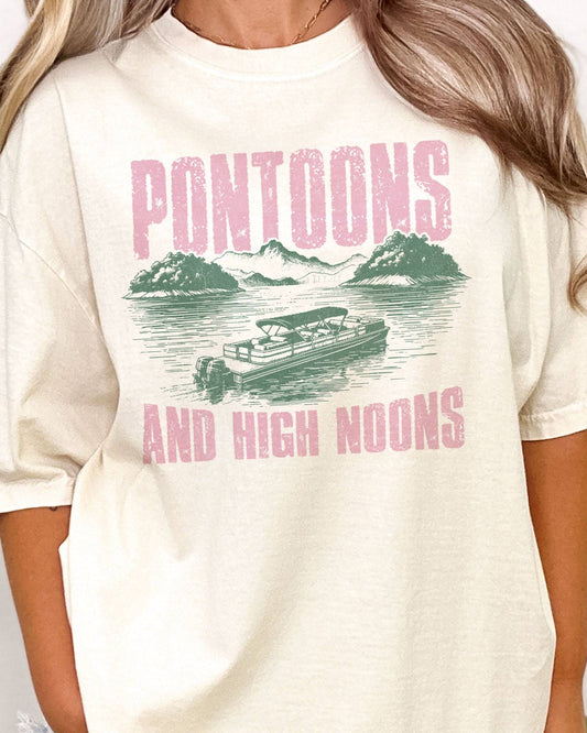 Close-up of Woman wearing "Pontoons And High Noons" shirt in ivory color with a retro graphic of a pontoon on a lake.