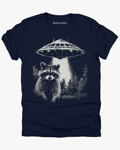 Flat lay navy blue 'Raccoon UFO' t-shirt featuring a funny graphic of a raccoon escaping a UFO abduction.