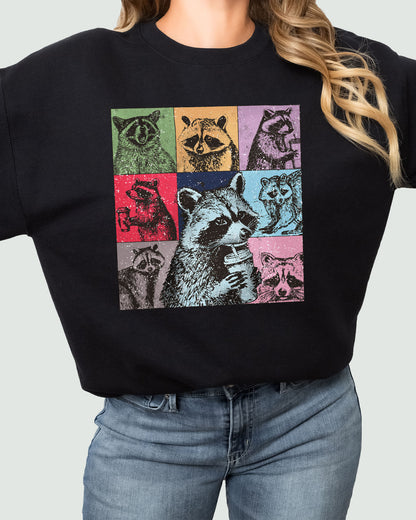 Woman wearing a sweatshirt in black, featuring a retro raccoons drinking coffee collage graphic design and unisex fit.