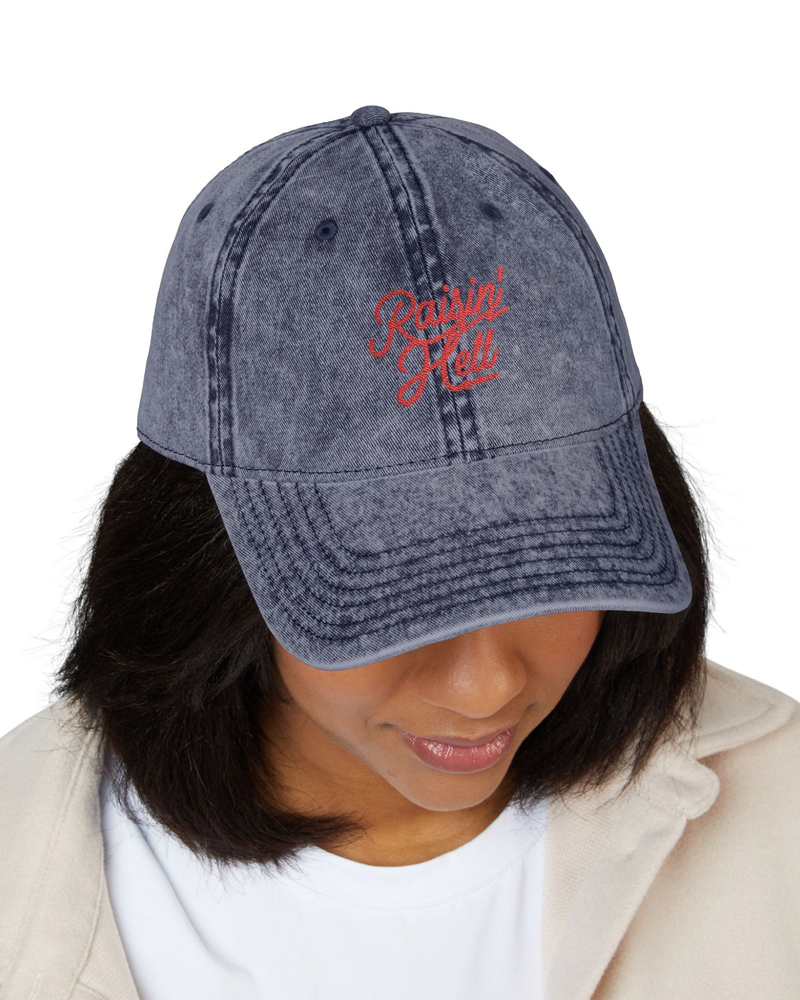 Woman wearing Raisin' Hell embroidered vintage cap in navy color