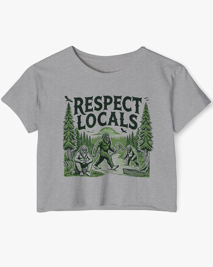 Flat-lay heather gray 'Respect Locals' crop top featuring a funny retro Bigfoot walking through the forest graphic.