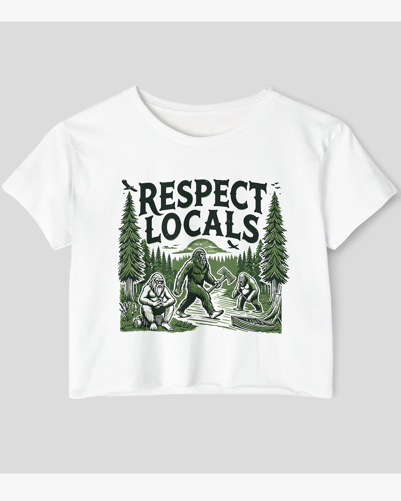 Flat-lay white 'Respect Locals' crop top featuring a funny retro Bigfoot walking through the forest graphic.