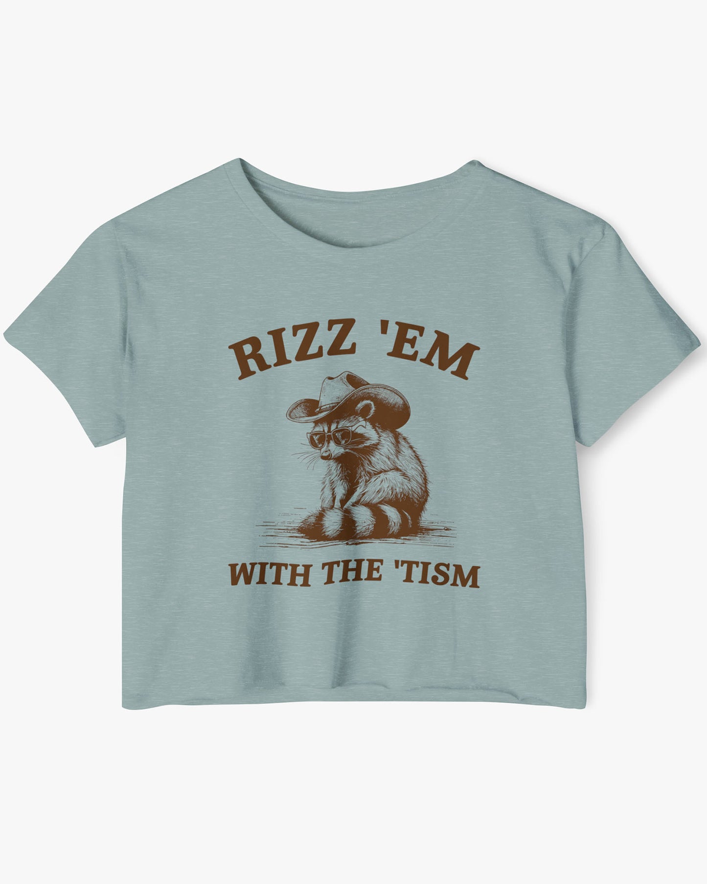 Flat lay stonewash green 'Rizz Em With The Tism' crop top featuring a funny retro cowboy raccoon graphic.