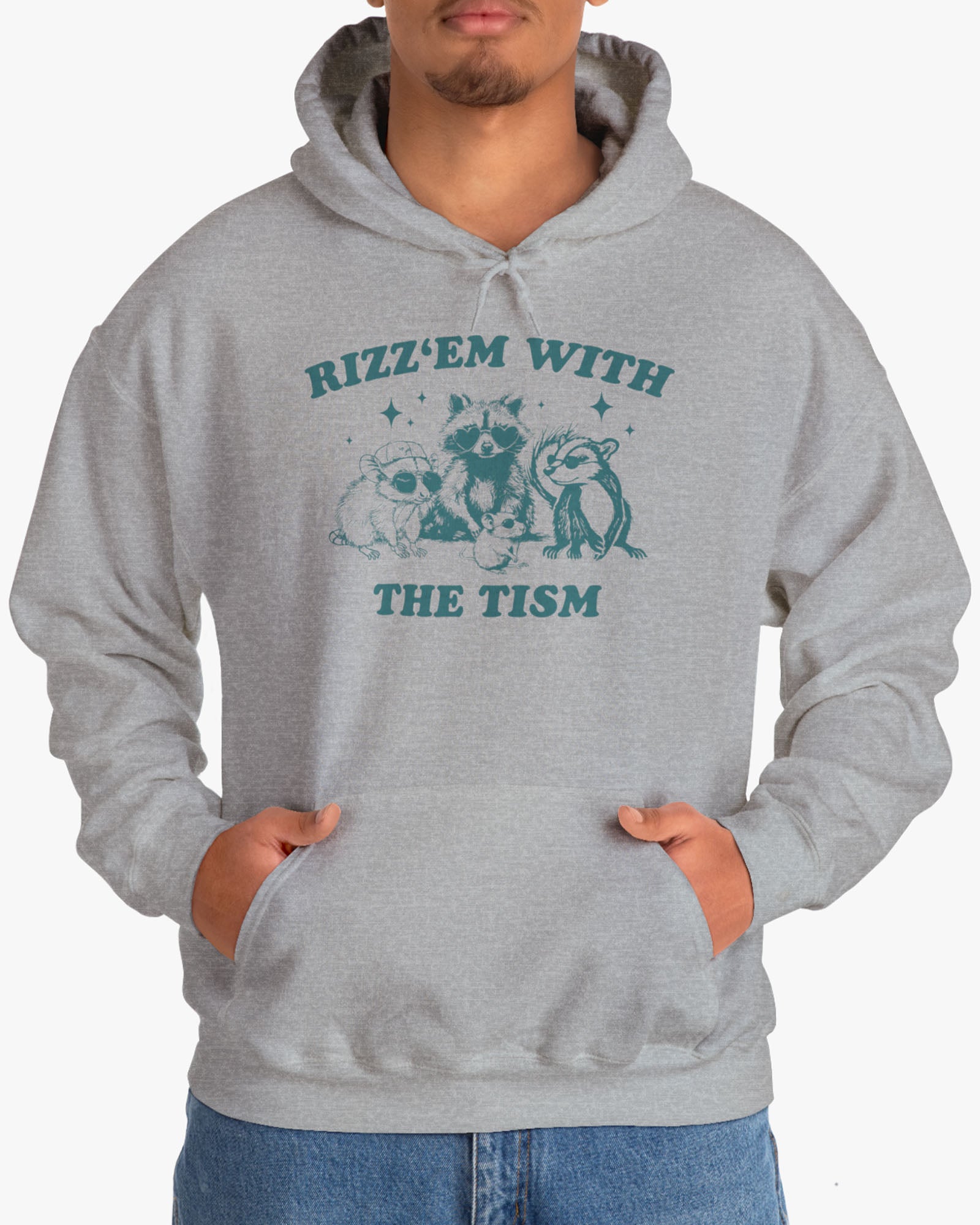 Man wearing a 'Rizz Em With The Tism' hoodie in sport gray, featuring a retro western graphic design and unisex fit.