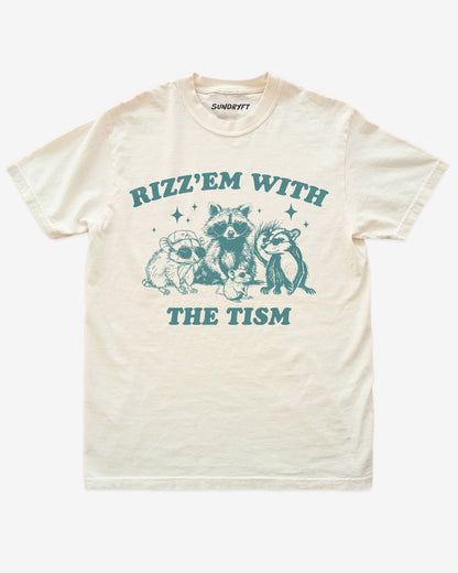 Ivory “Rizz Em With The Tism” funny retro raccoon autism awareness shirt flat lay.