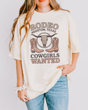 Model wearing ivory color shirt with 'Rodeo Houston Texas Cowgirls Wanted' graphic design