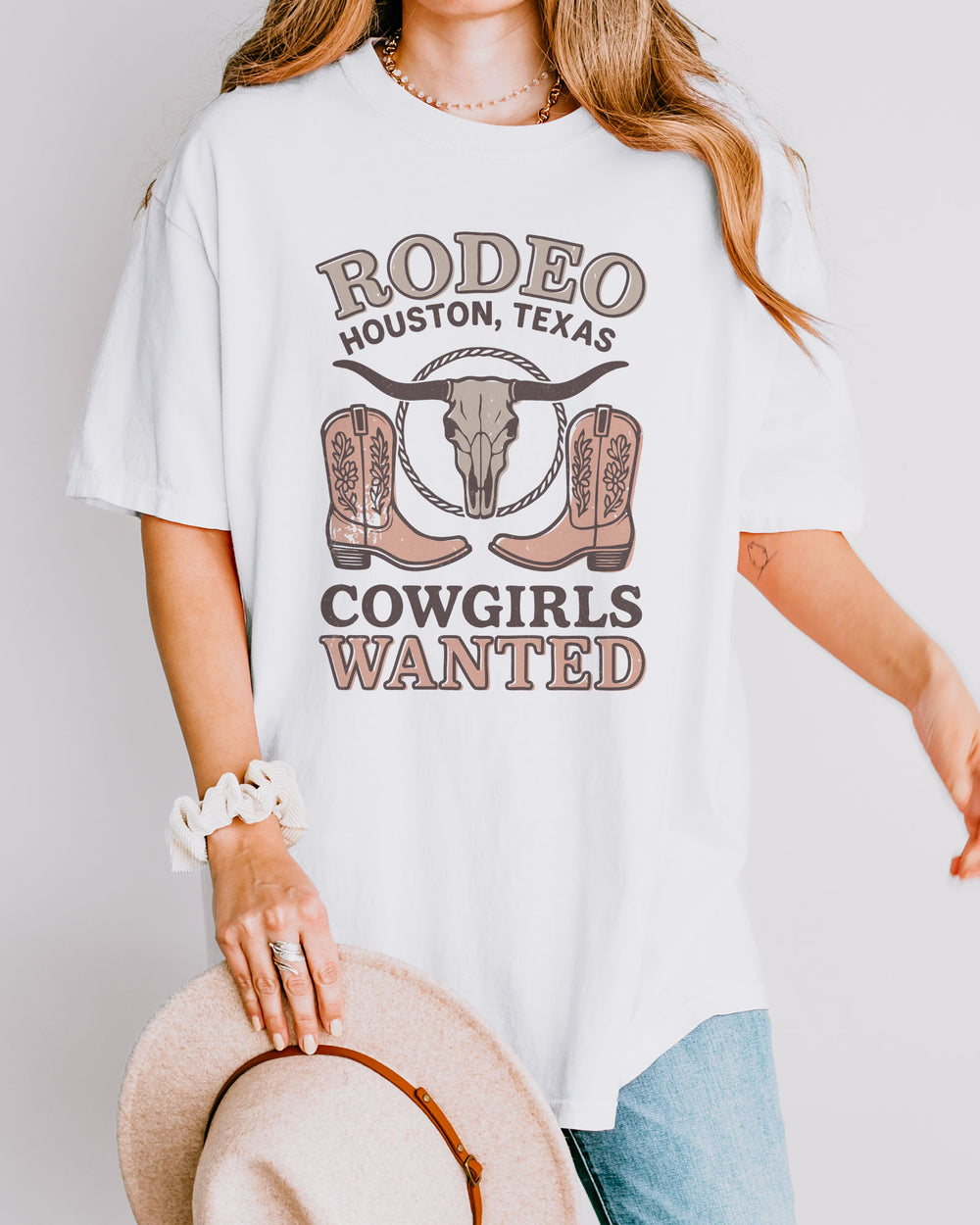 Model wearing white color shirt with 'Rodeo Houston Texas Cowgirls Wanted' graphic design