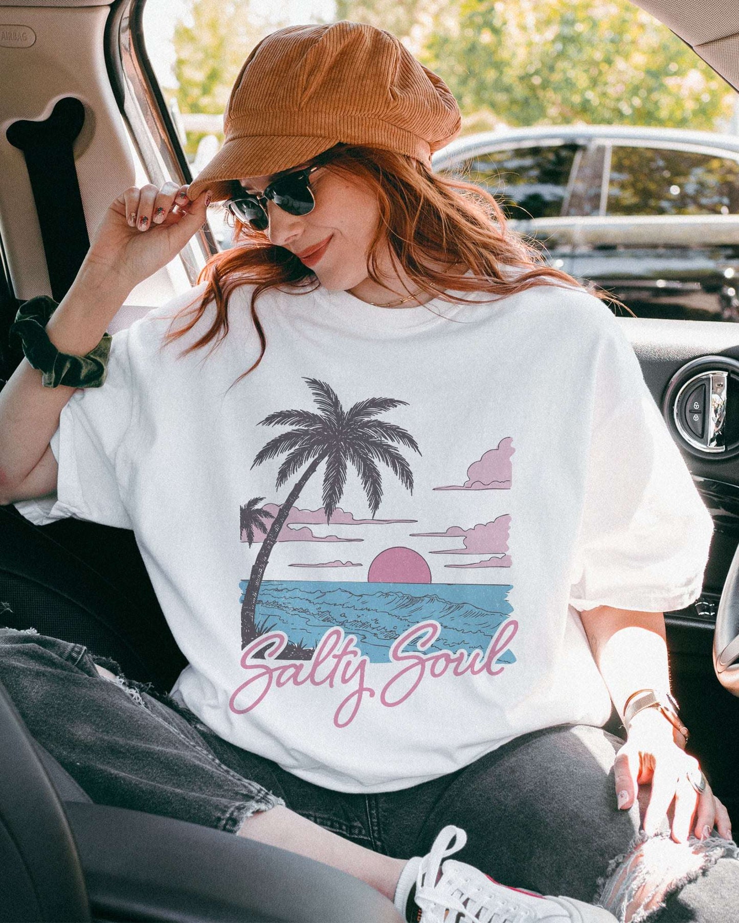 Model wearing white color shirt with 'Salty Soul' funny retro beach graphic design