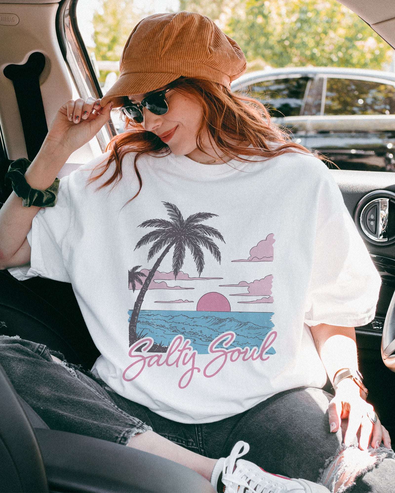Model wearing white color shirt with 'Salty Soul' funny retro beach graphic design