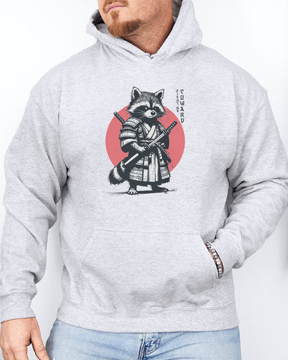 Man wearing an ash gray hoodie featuring a retro funny samurai raccoon graphic with the quote 'Fight Me Coward' in a Japanese-style font.