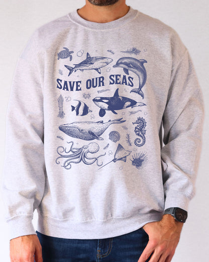 Model wearing ash color sweatshirt with 'Save Our Seas' graphic design