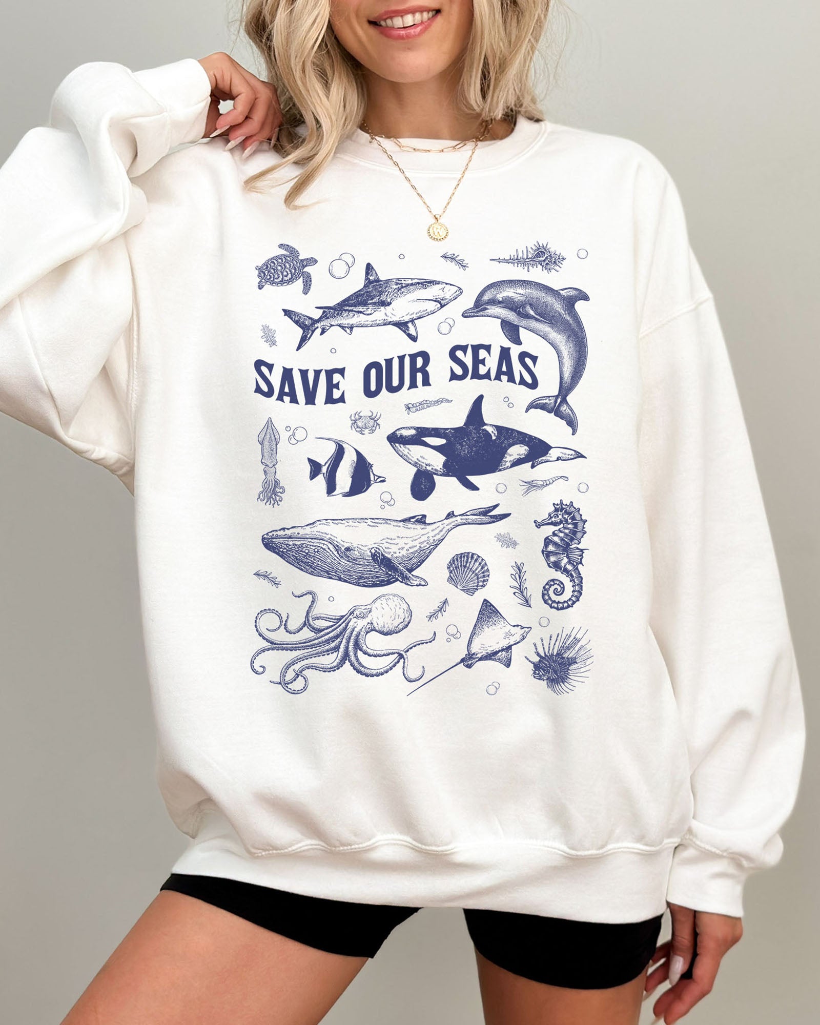 Model wearing white color sweatshirt with 'Save Our Seas' graphic design